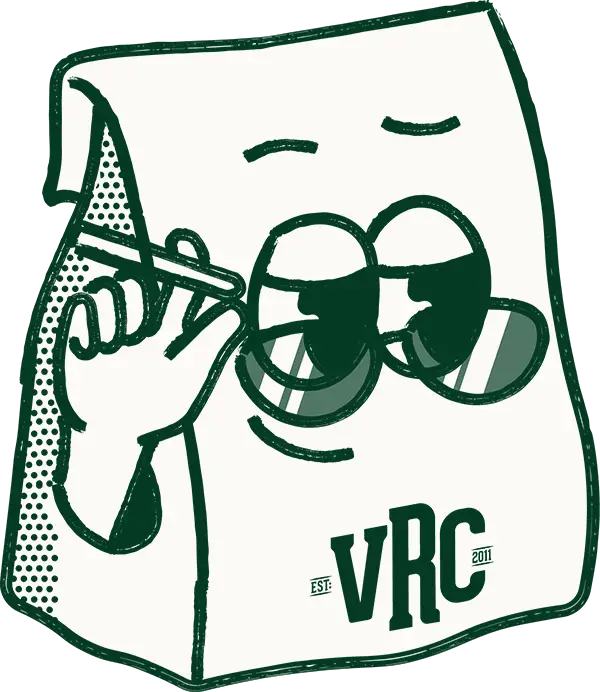 VRC Est. 2011 mascot — a cartoon paper bag wearing sunglasses and holding a pen