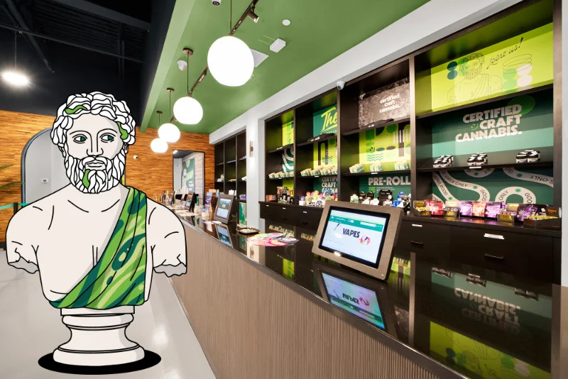 Interior of a cannabis dispensary with a service counter, product shelves, and a Greek bust illustration in the foreground