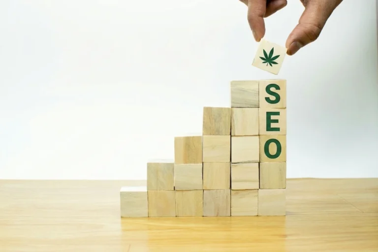 Wooden blocks spelling SEO with a cannabis leaf block being added, symbolizing compounding growth in cannabis marketing SEO