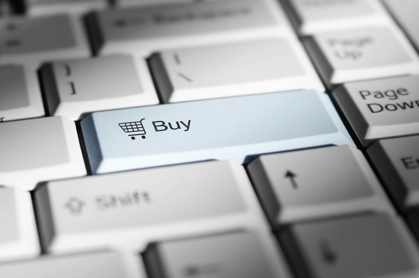 Close-up of a dedicated 'Buy' key on a keyboard, representing checkout friction when choosing a cannabis ecommerce platform