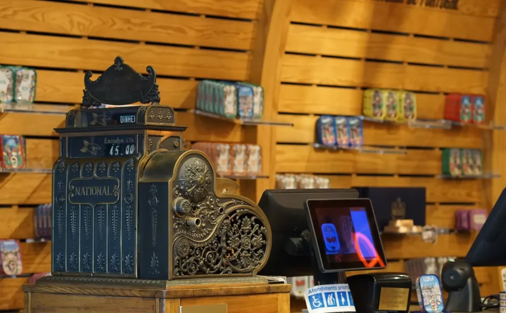 Vintage cash register next to a modern touchscreen POS, representing how cannabis ecommerce platforms handle transactions but not customer acquisition